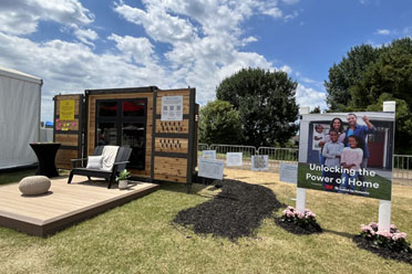 A shipping container transformed into a display for the Habitat for Humanity Partnership at the 3M Open.